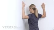 Woman doing a corner stretch.