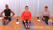 Three people doing a seated toe touch basic hamstring stretch.